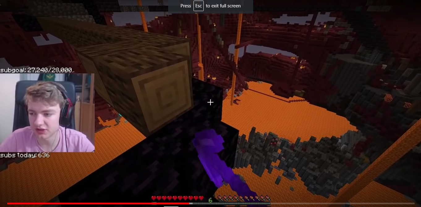 This is a screenshot from Tommy's stream. He's in the nether fixing an oak log bridge into a one-block wide obsidian bridge. His webcam shows him at an awkward and unflattering time midsentence.